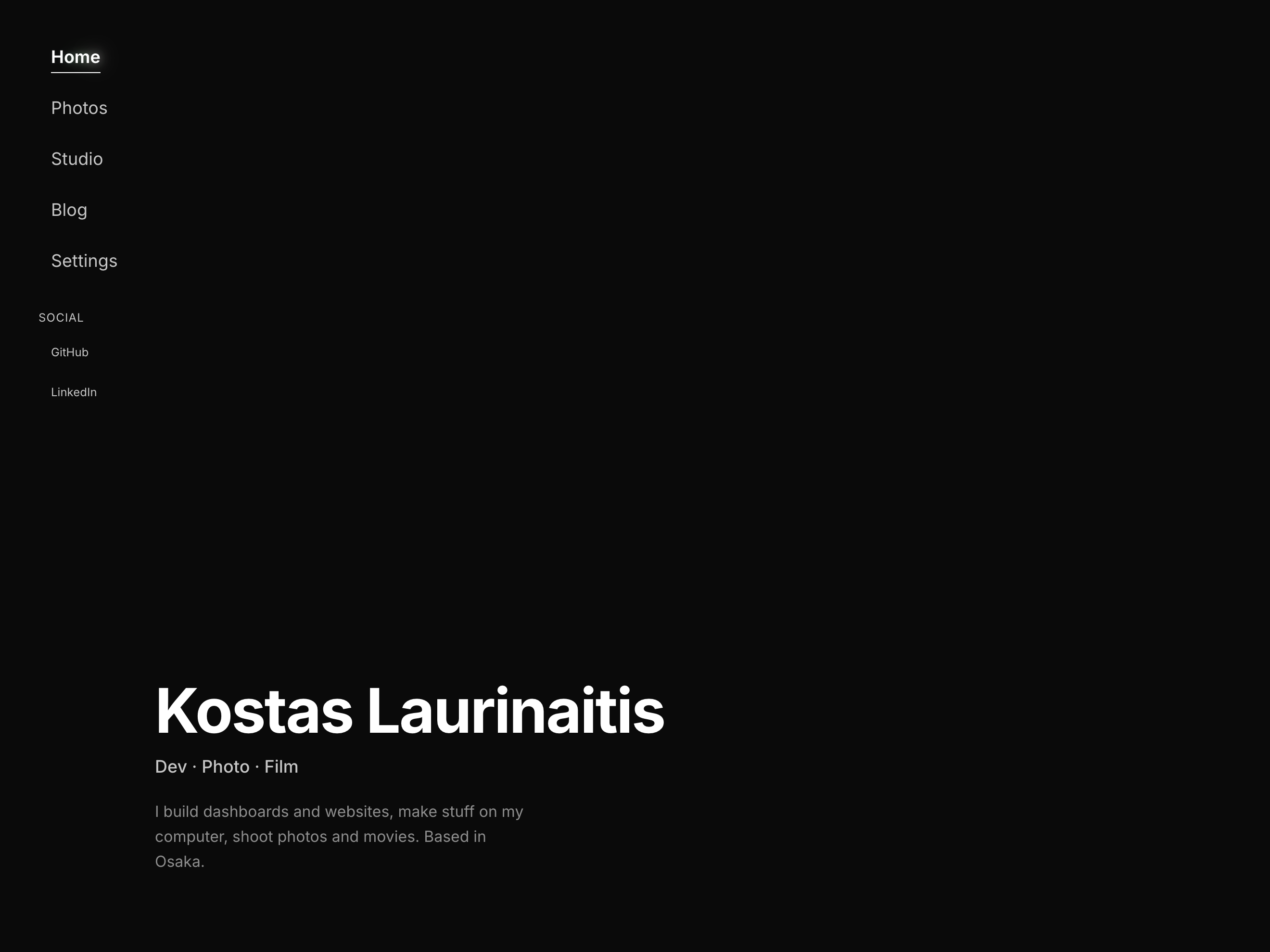 The first static homepage, with the name, role line and short bio bottom-left on a near-black background and the shader switched off.