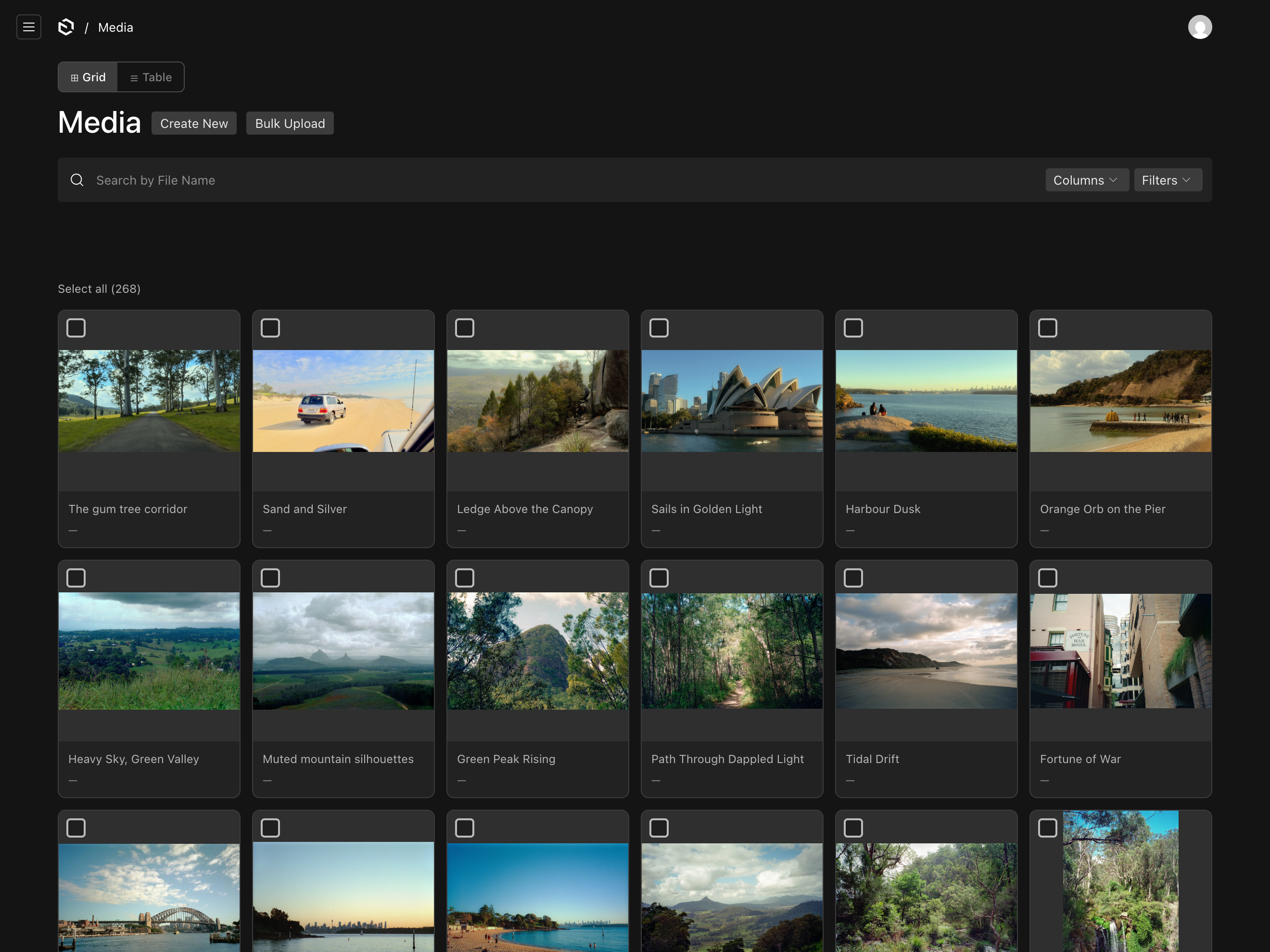 The media library in grid mode, with thumbnail cards, a checkbox on each and the grid and table toggle above.
