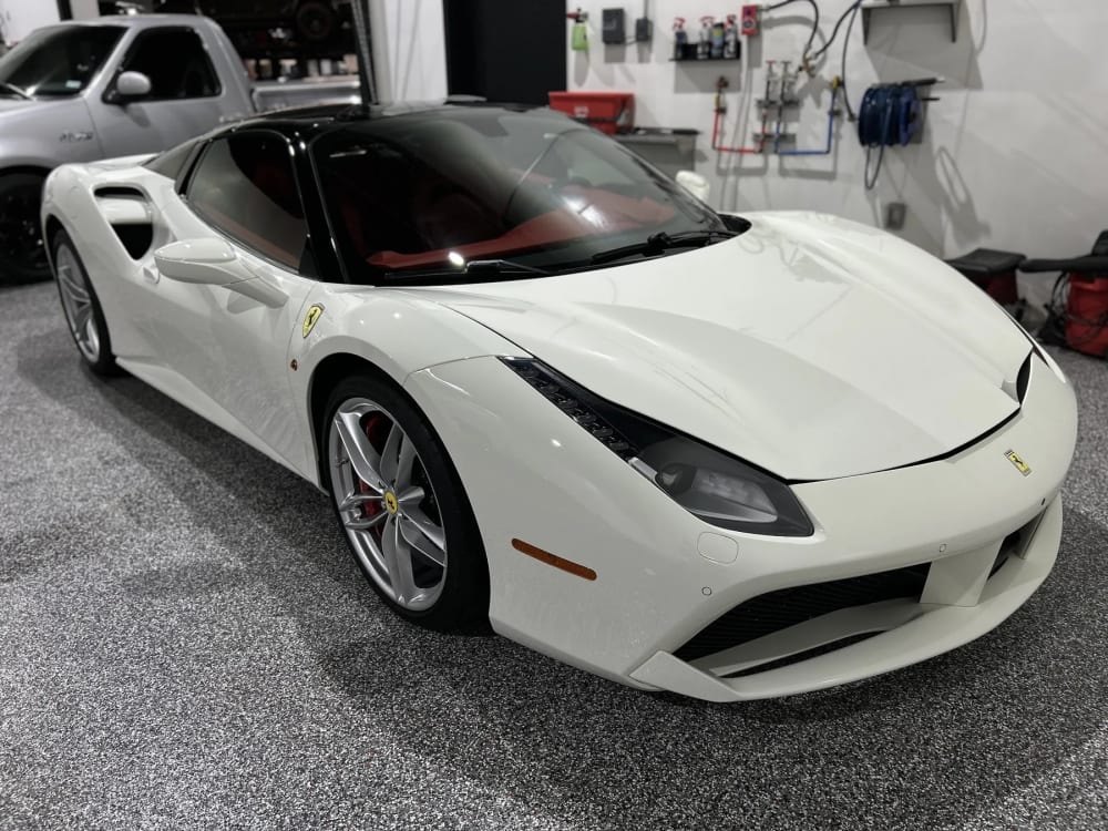 White Corvette in a Prismatic Car Care shop bay