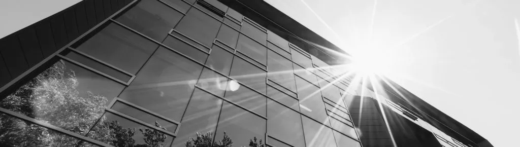 A glass office building exterior seen from the street