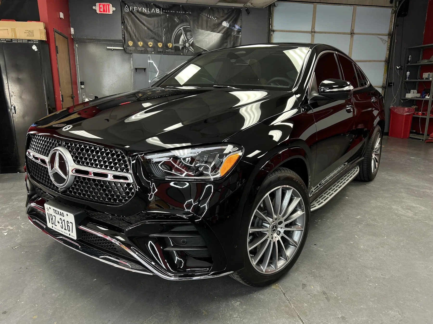 Black Mercedes GLE detailing in shop background