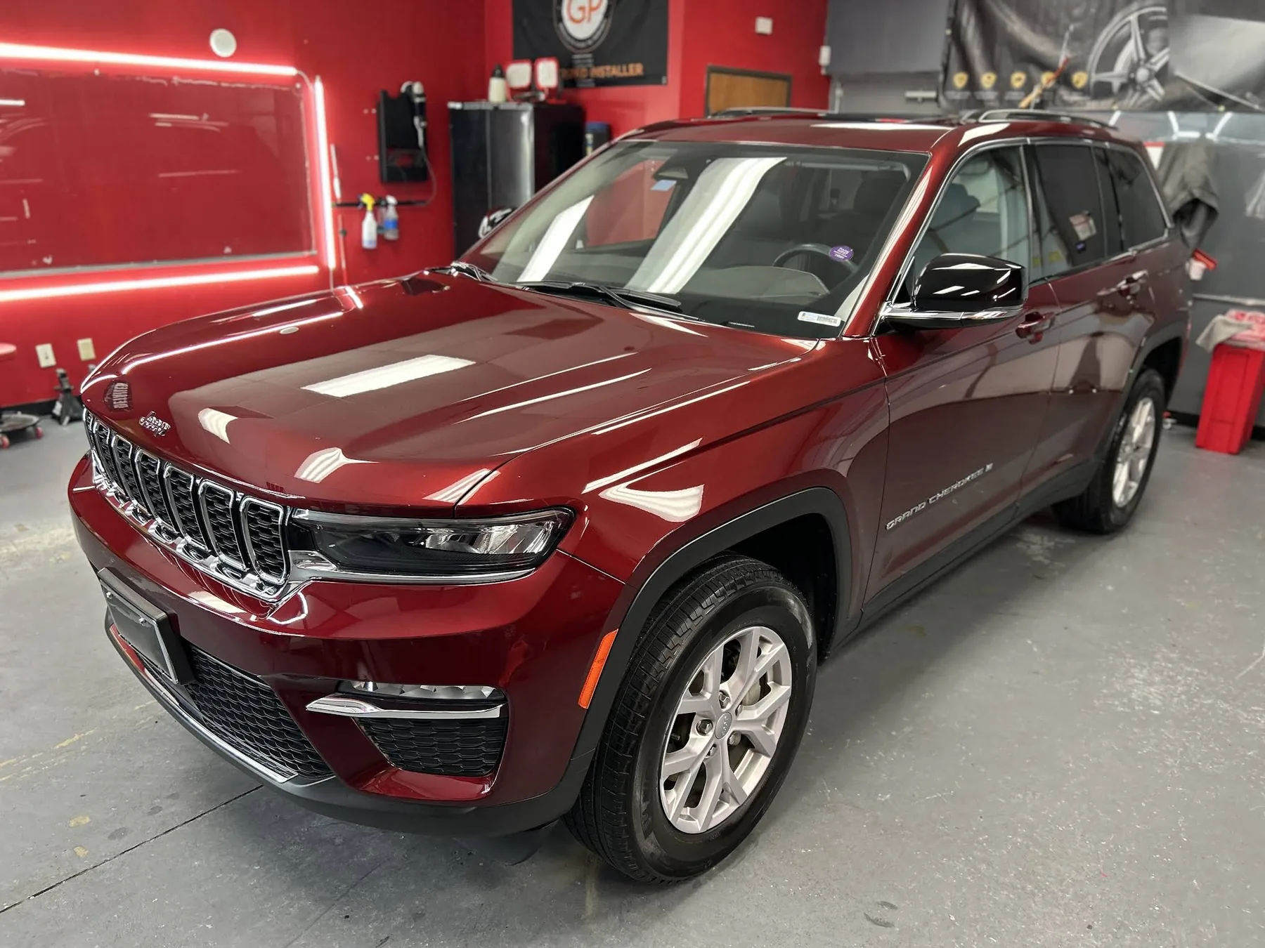 Red Jeep Grand Cherokee receiving professional ceramic coating at Prismatic Car Care Forney studio