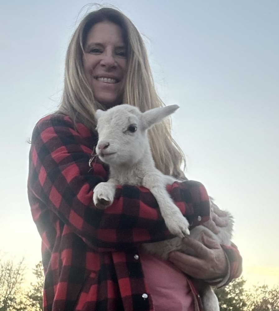 Portrait of Angela on the farm, ideally with animals nearby