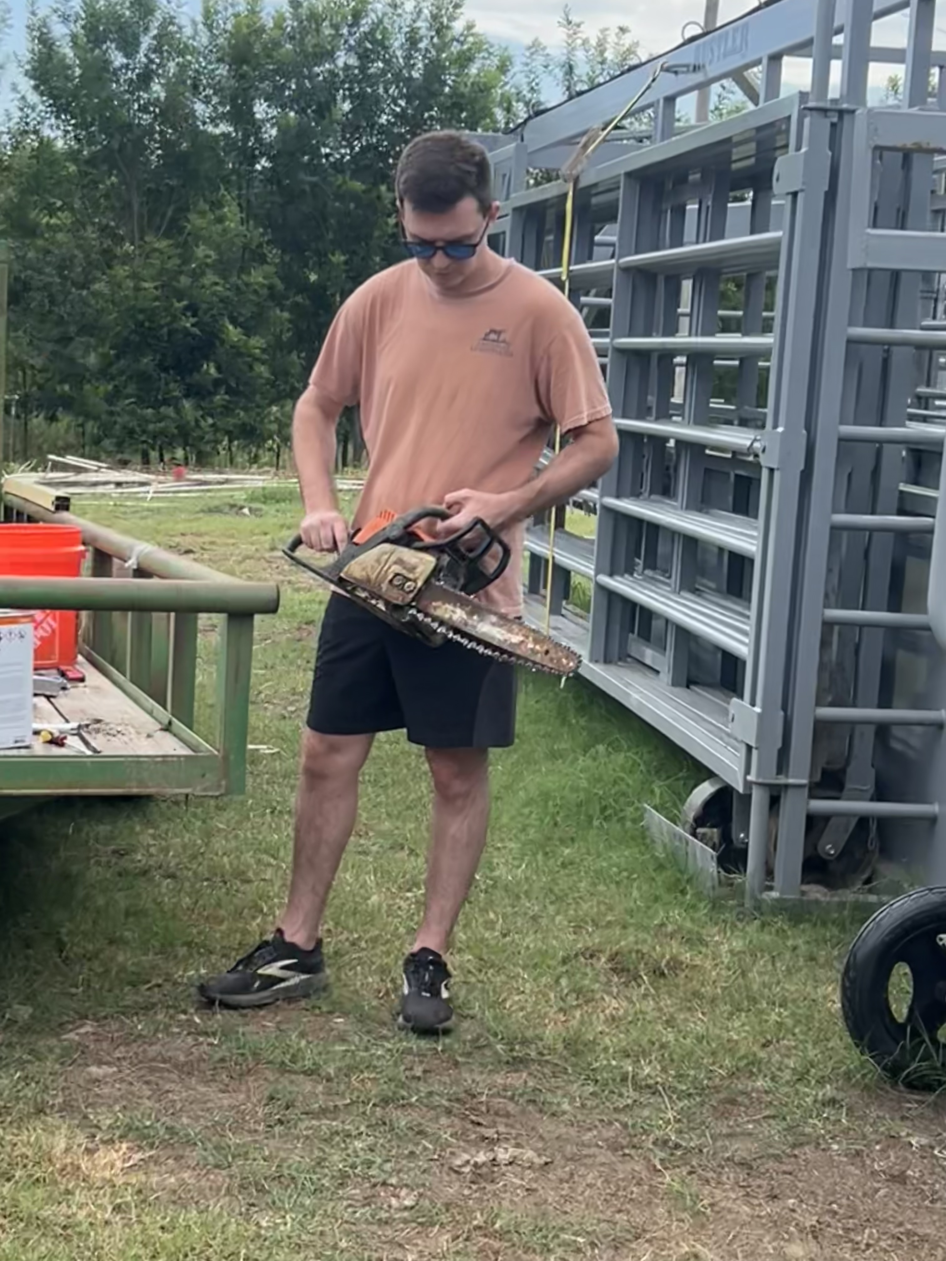 Portrait of Aaron, maybe fixing a fence or interacting with the animals