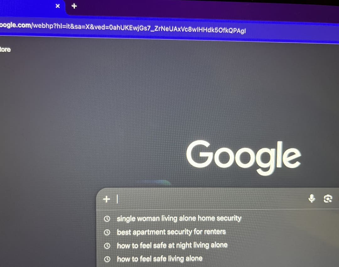 Laptop and phone on a table searching apartment security for women living alone
