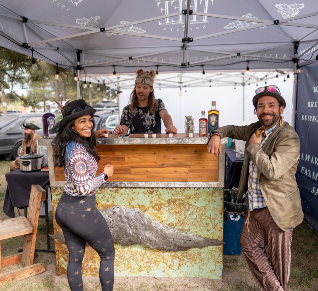 People smiling at a bar during an event in Bend, Oregon