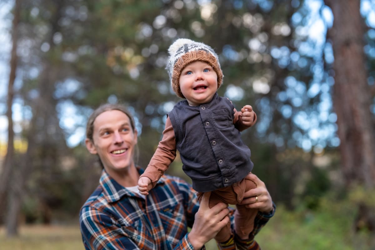 Dad playing with baby outdoors