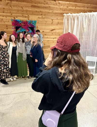 Amanda taking a Polaroid photo of a group at an event