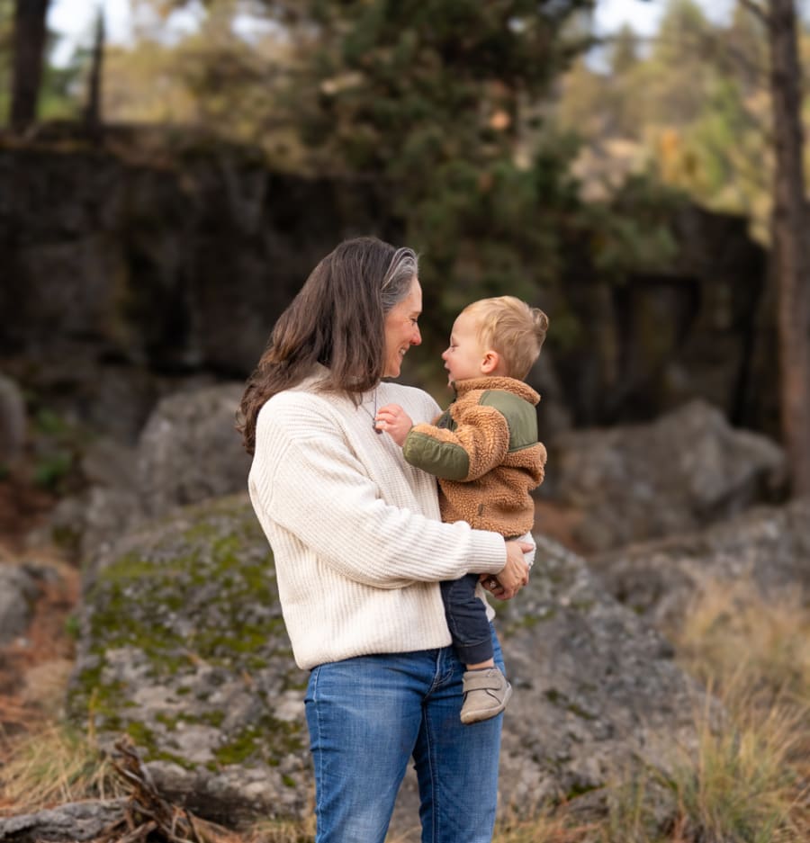 Mom and son playing together during a natural family photography session in Bend