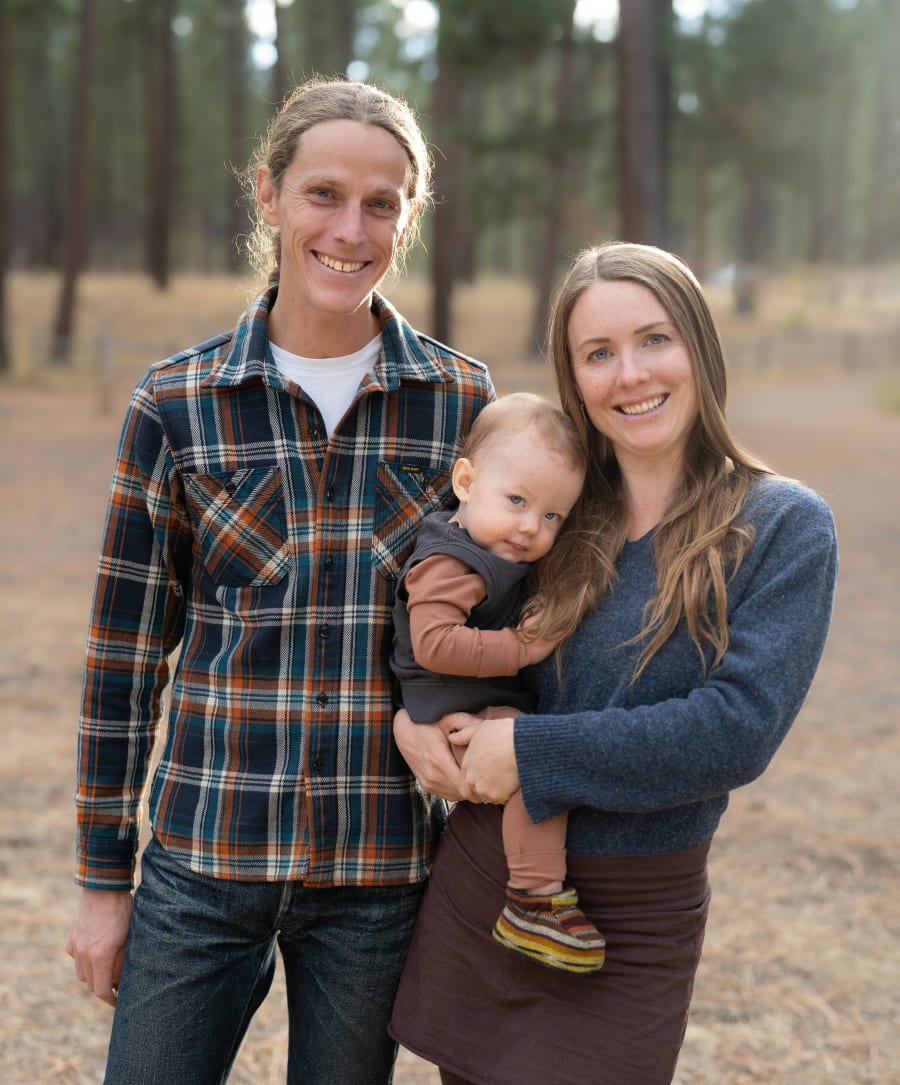 Mom, dad, and baby smiling together during a family photography session in Central Oregon