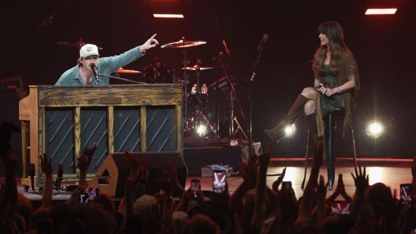 Watch Morgan Wallen & Ella Langley Perform ‘Sand In My Boots’ Live In Nashville