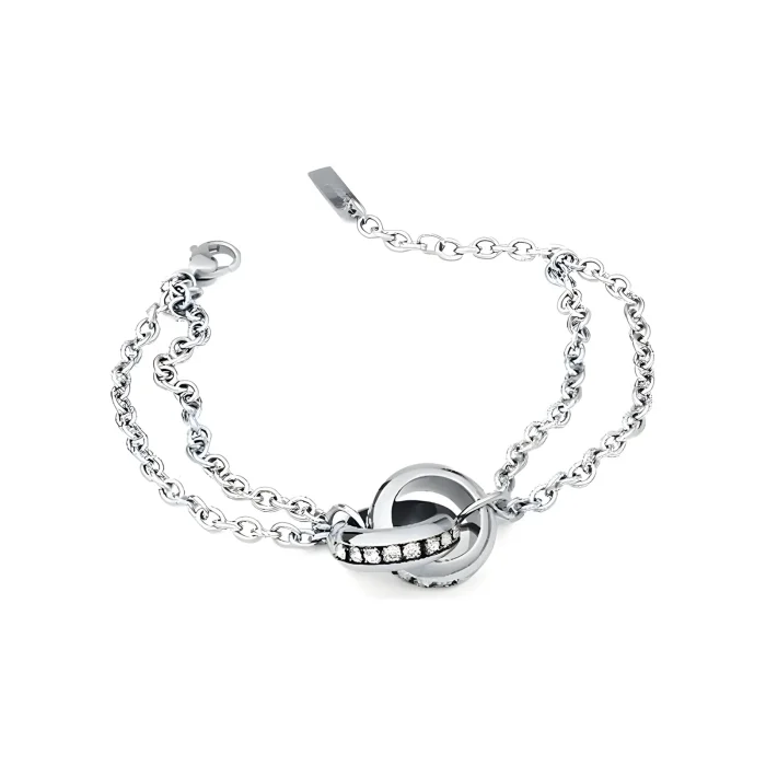 Silver bracelet featuring intertwined loops and a sparkling band of gems, showcasing elegance and modern design.