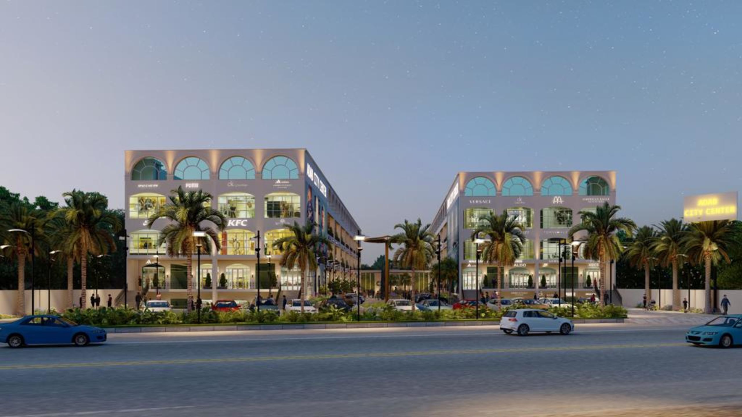 Street elevation of a two-wing open-air retail centre lit at dusk