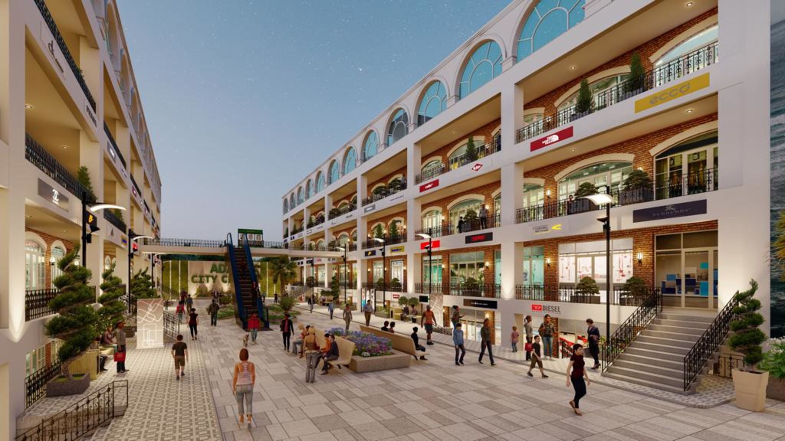 Pedestrian promenade between arcaded shopfronts with a link bridge