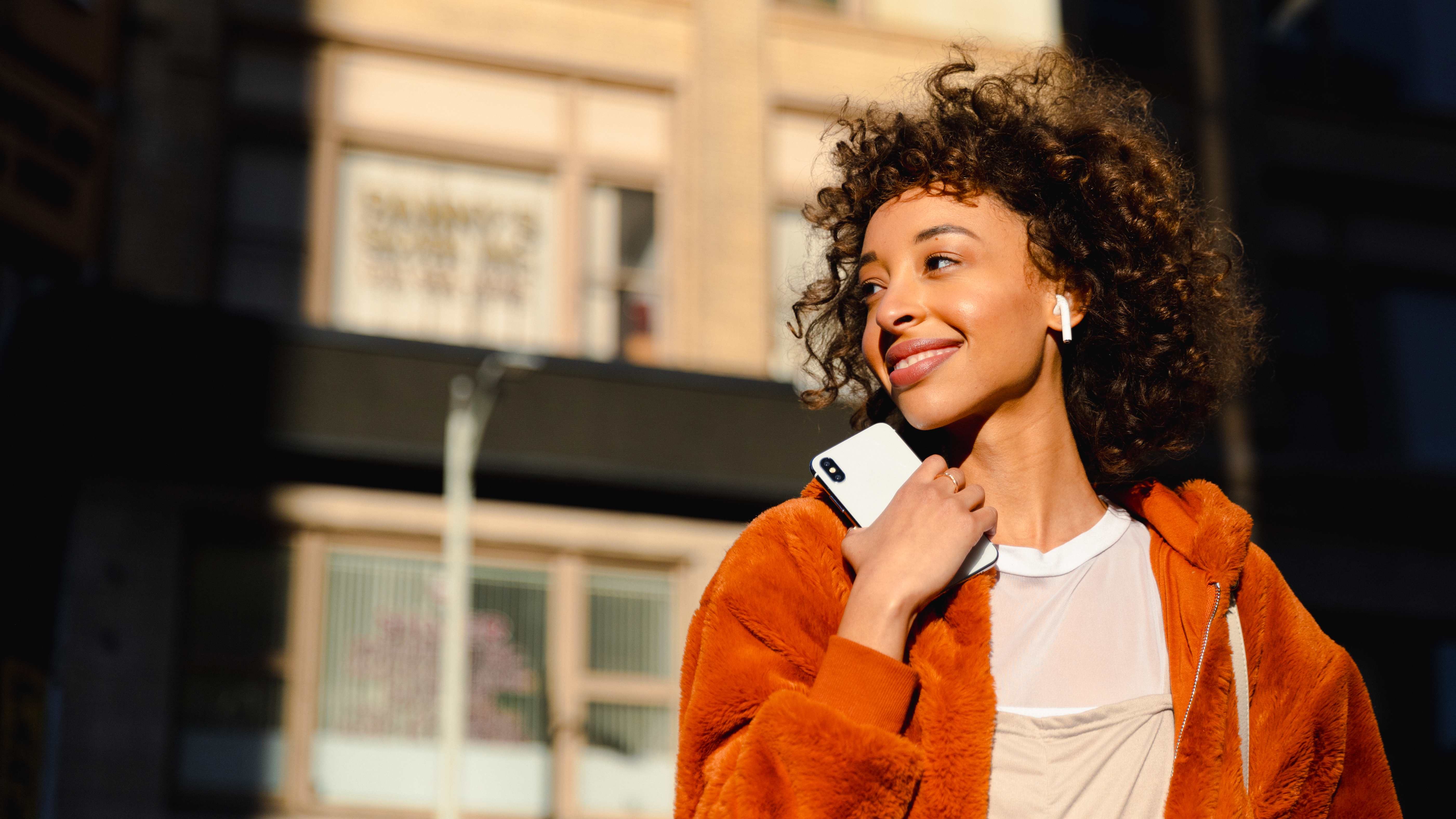 Mulher usando smartphone com PayzuCell - Conectividade móvel integrada