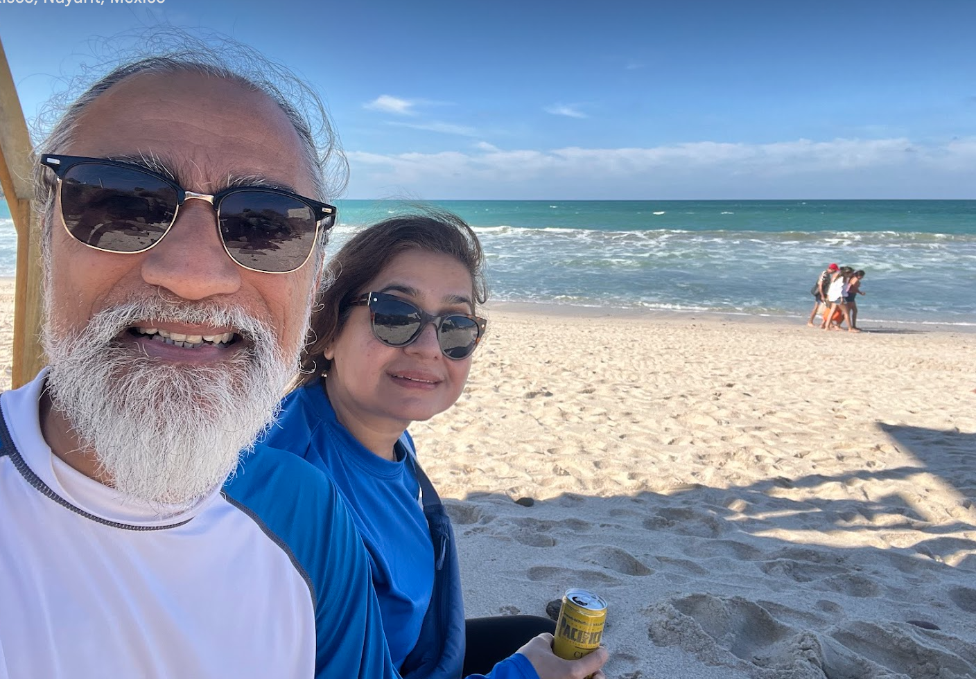 Couple relaxing on the beach at sunset