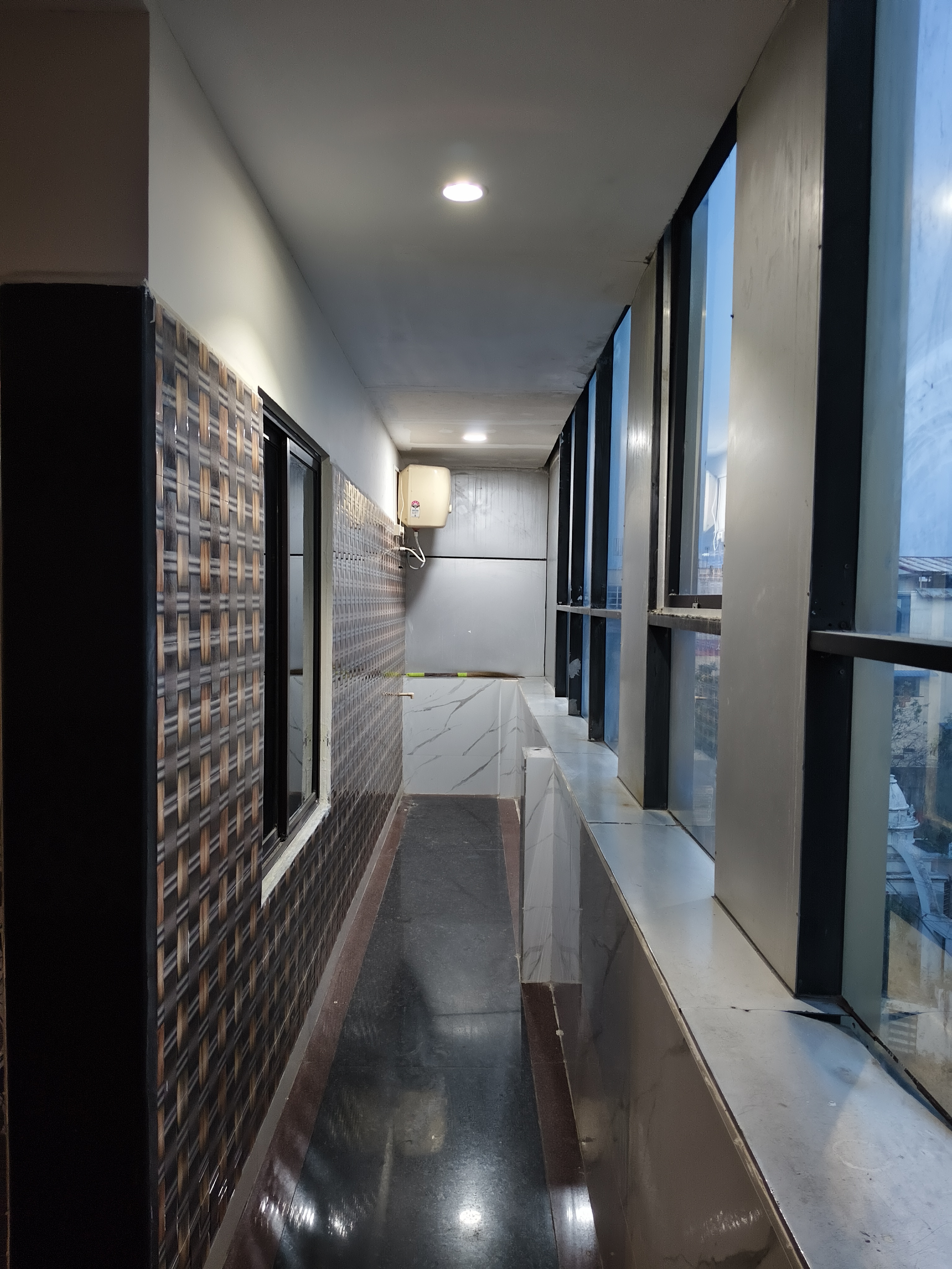 Bright interior walkway with large windows at Emirates Inn
