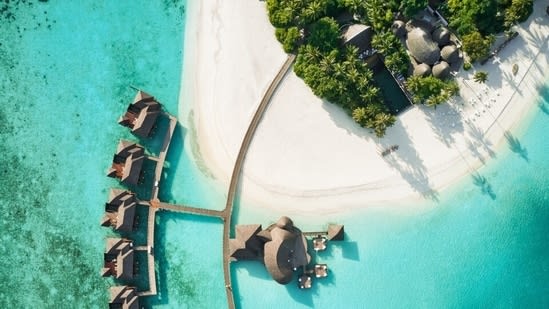 Inside Sun Siyam Iru Fushi where quiet luxury meets charming overwater villas, Maldivian hospitality, gourmet dining