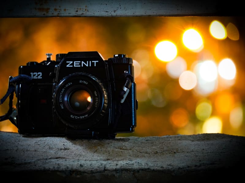 Zenit 122 film camera with a Zenitar 50mm lens, warm bokeh in the background