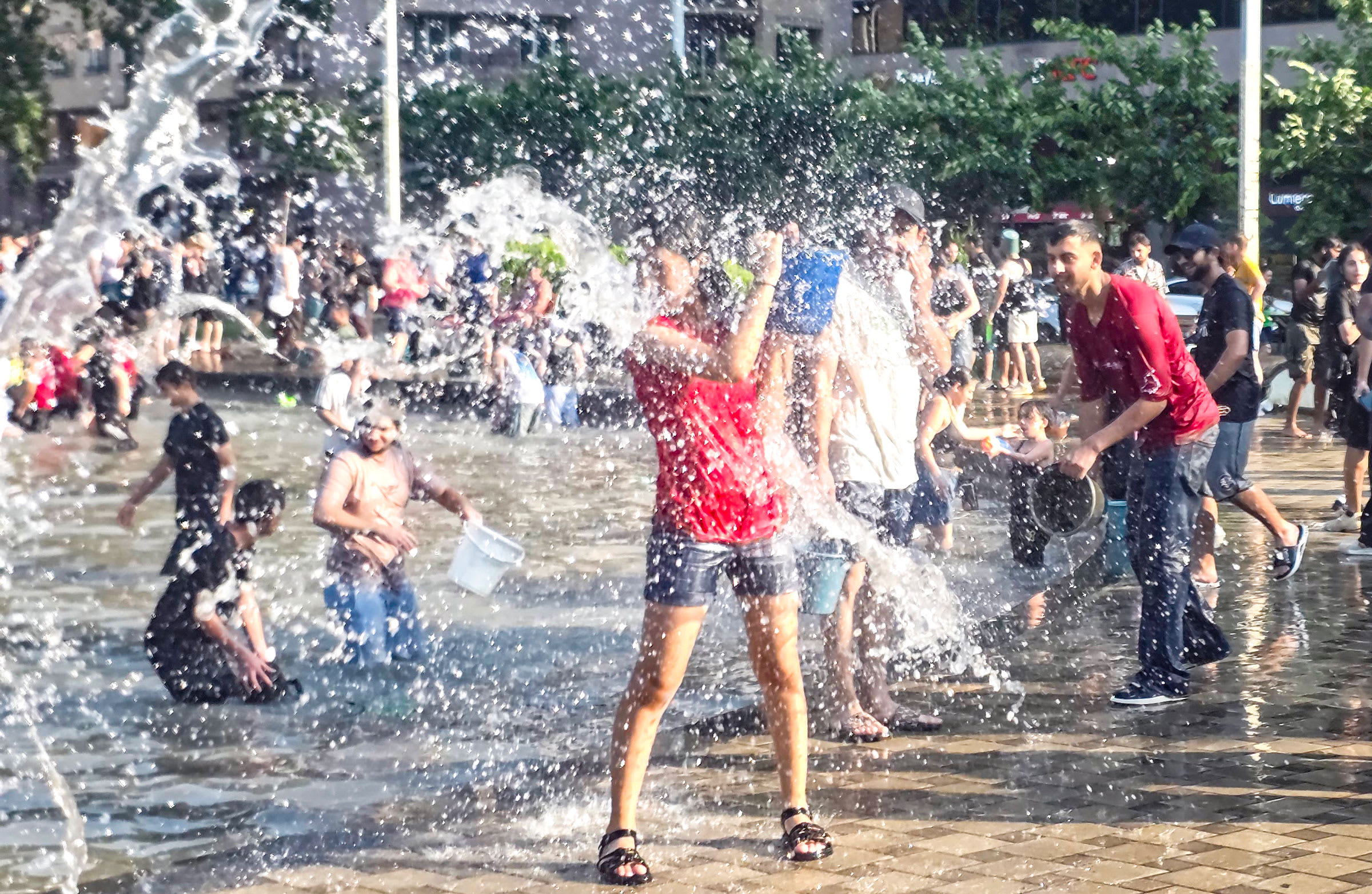 People splashing water during Vardavar festival at Republic Square in Yerevan, Armenia
