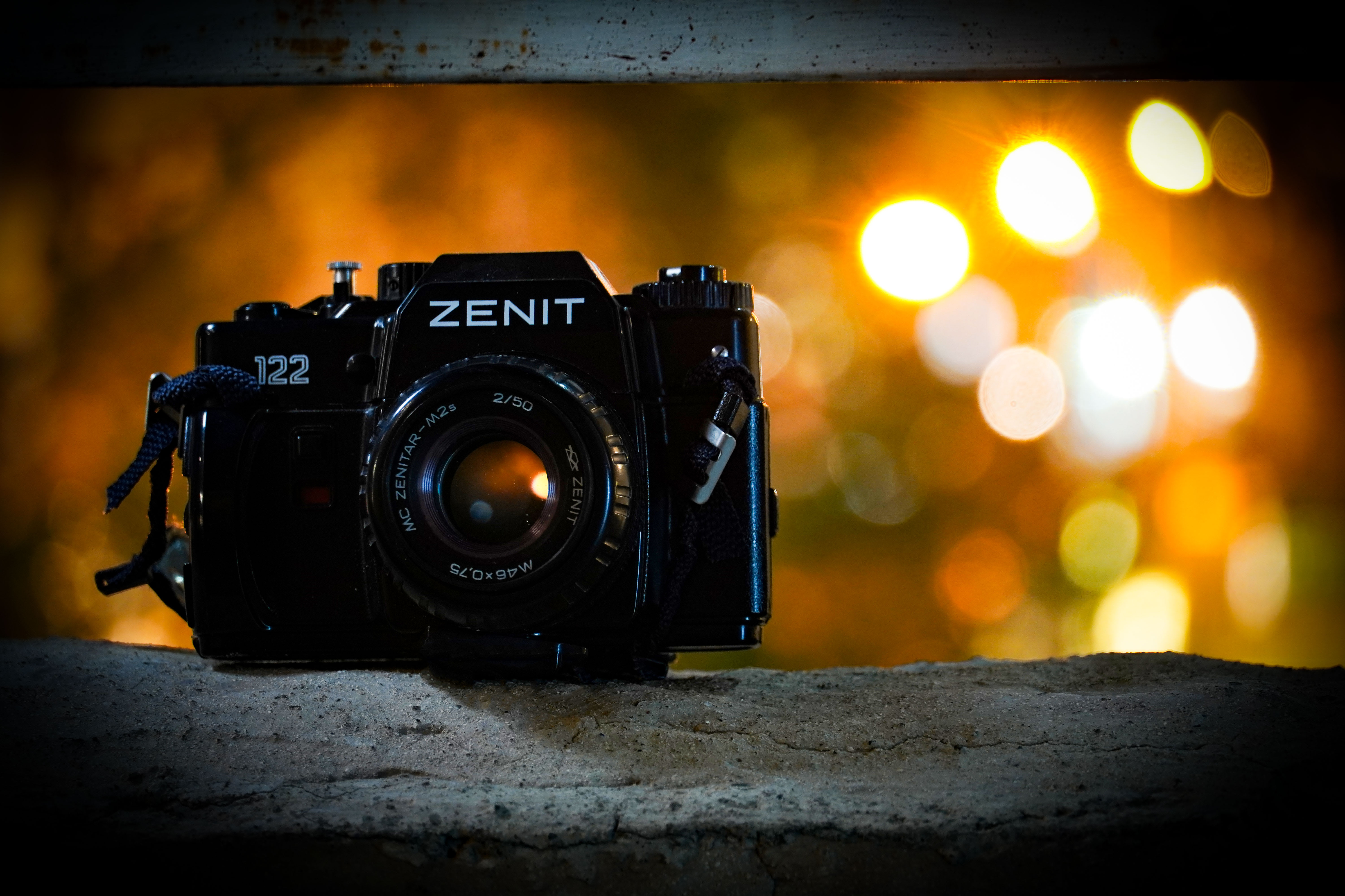 Zenit 122 film camera with a Zenitar 50mm lens, warm bokeh in the background