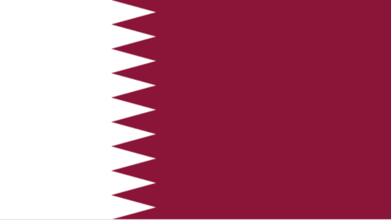 The national flag of Qatar, featuring a white band on the left separated from a maroon band on the right by a zigzag pattern with nine points.