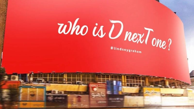 A large red billboard on a building reads 'Who is D nexT one?' with the hashtag #lindseygraham, featuring a Tasnim News watermark, appearing to be located in Iran.