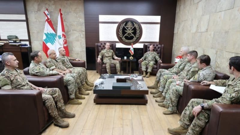 Military officials in uniform seated in a formal meeting room at the Lebanese Armed Forces headquarters, with the Lebanese Army emblem and flags visible in the background.
