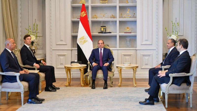 A formal diplomatic meeting in an ornate room with the Egyptian flag displayed prominently, featuring several men in suits seated in gilded chairs around small tables in what appears to be an Egyptian presidential palace.