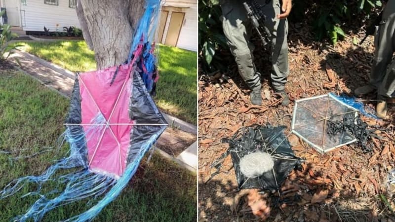 Two side-by-side photos showing incendiary kites recovered on the ground. The left image shows a pink and black kite with blue plastic streamers caught against a tree trunk on a lawn. The right image shows makeshift kite devices with attached incendiary payloads on mulch-covered ground, with an armed soldier's legs visible.