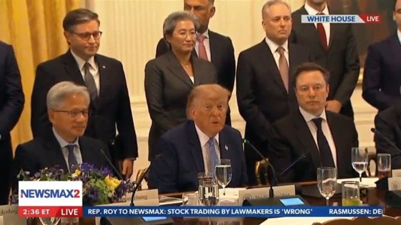 A live Newsmax2 broadcast from the White House showing a formal meeting or event with multiple individuals seated and standing around a conference table, with news ticker visible at the bottom.