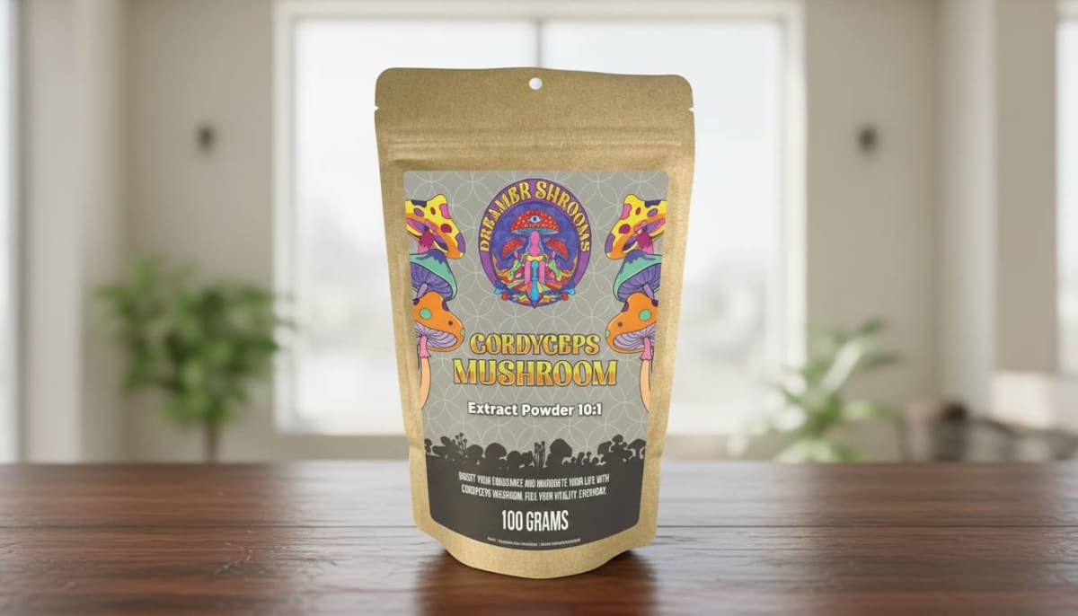 Dreamer Shrooms pale orange cordyceps powder stirred into a glass of hot tea