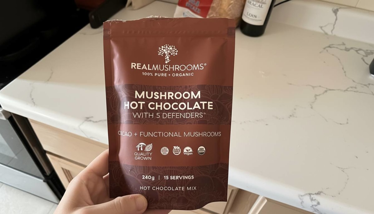 Real Mushrooms Organic Hot Chocolate Mix prepared in a dark mug