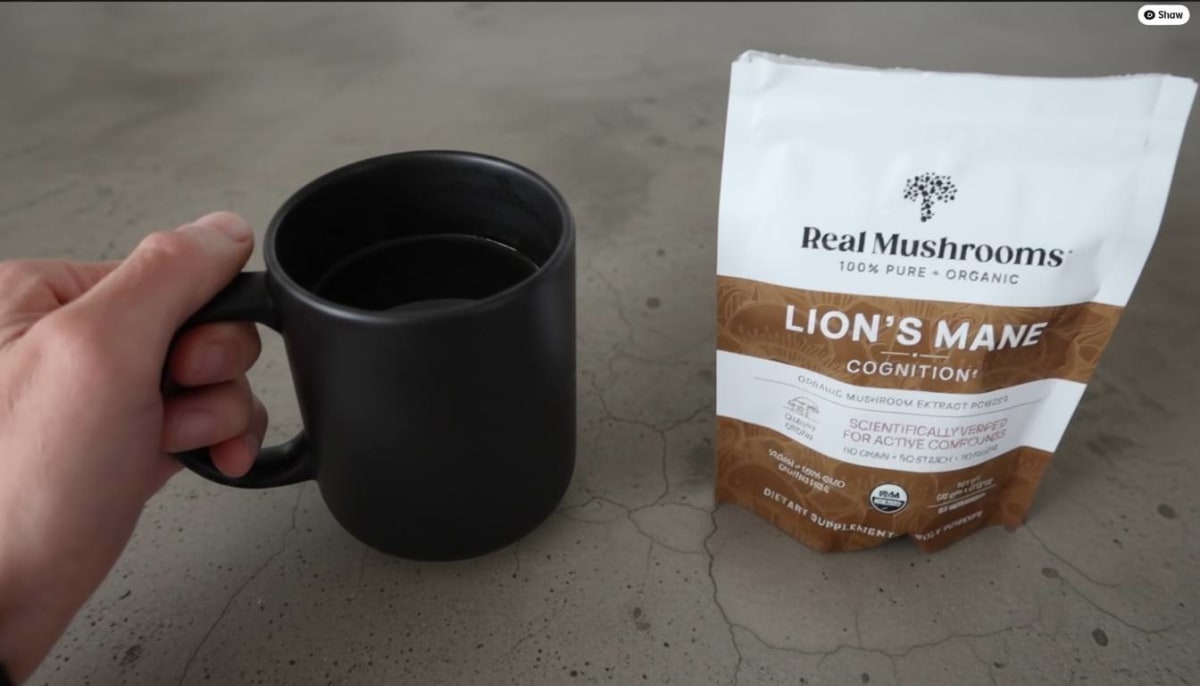 Real Mushrooms Lion's Mane Powder being stirred into decaf coffee