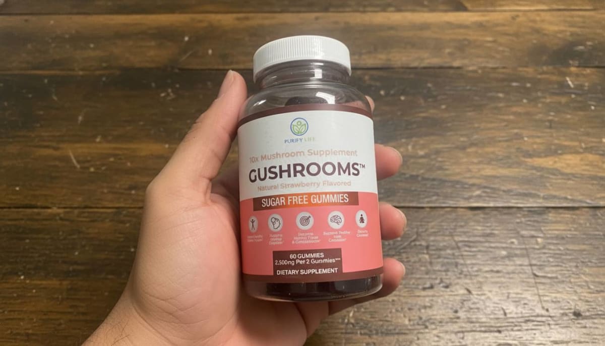 Purify Life mushroom gummies jar open on a desk with a morning coffee