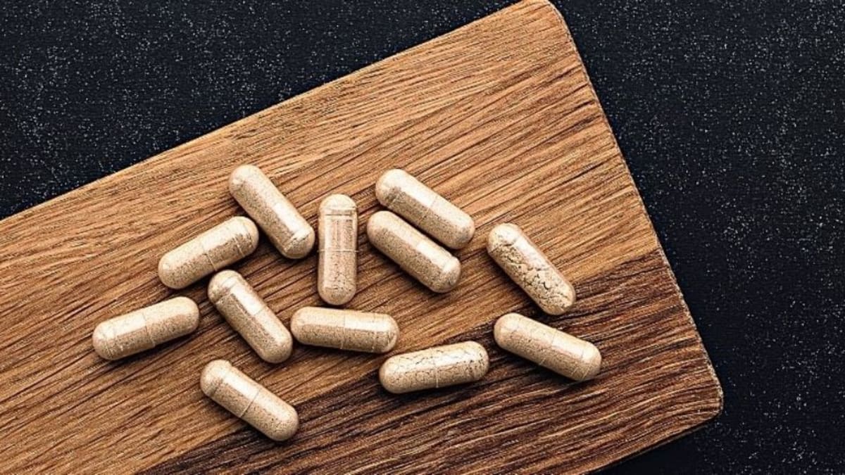 Lion's mane capsules on a wooden surface