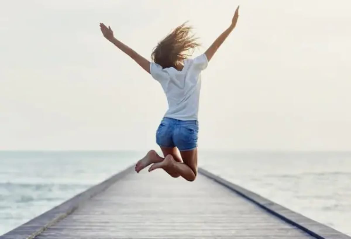 Person holding a cup of mushroom-infused coffee with lion's mane extract powder nearby