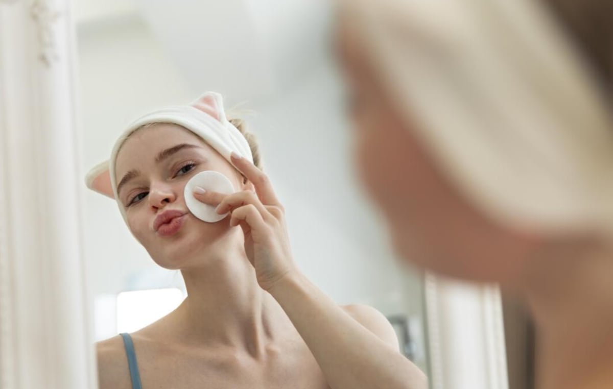 Person applying face serum with reishi mushroom extract