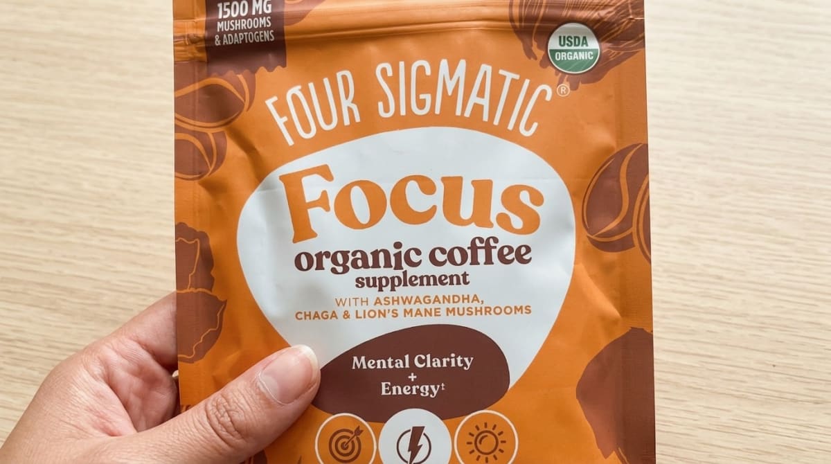 Bag of Four Sigmatic Focus Ground Coffee next to a French press on a kitchen counter
