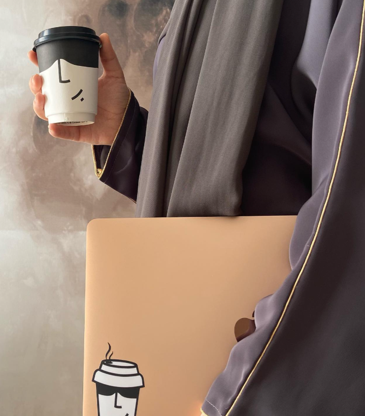 hands holding cup of coffee