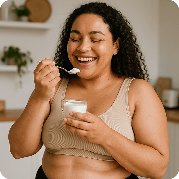 Happy woman eating a delicious yogurt