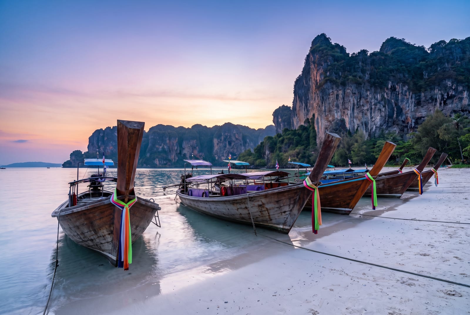 Railay Beach, Krabi — longtail boats on white sand