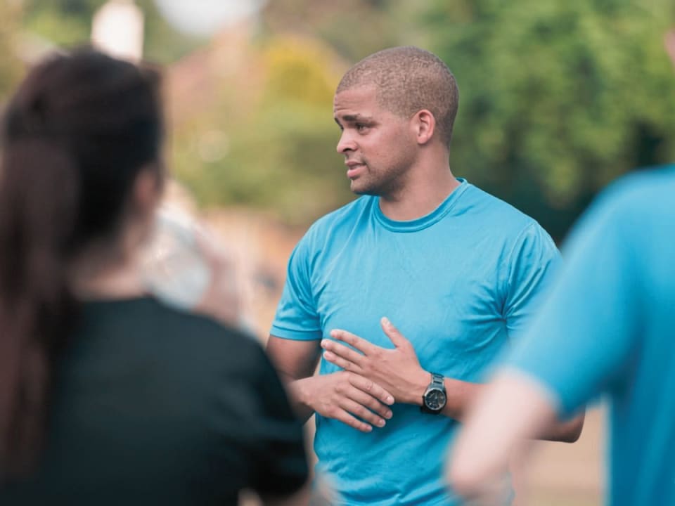 Jem Scragg coaching a group outdoors