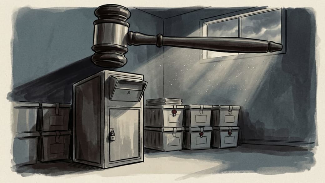 Illustration: ink-wash editorial illustration of a sealed ballot drop box and storage bins in an empty election office, sheltered beneath the shadow of a large judge's gavel as storm light streams through a window.