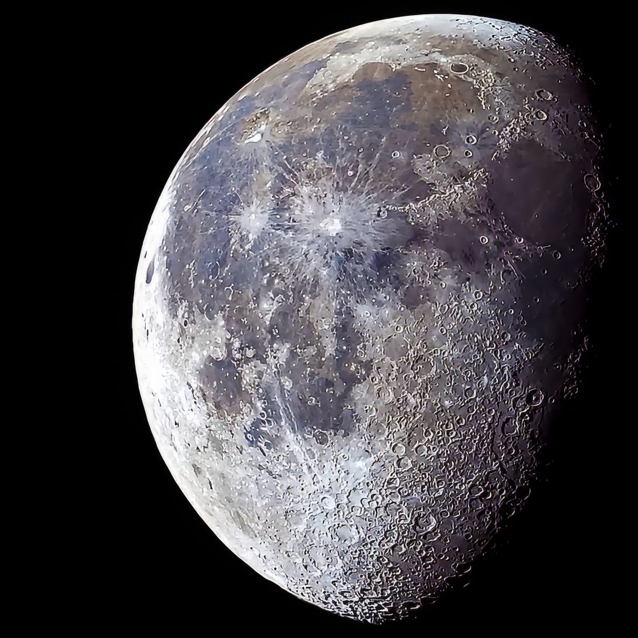 A gibbous Moon in enhanced colour, its dark plains tinted blue against grey highlands