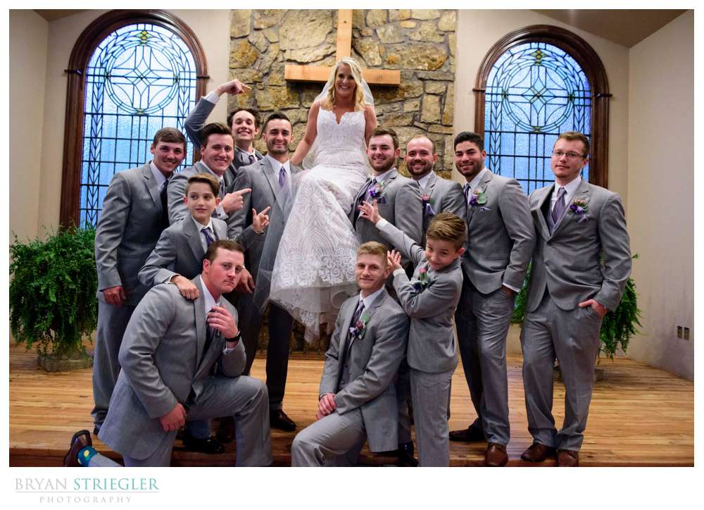 groomsmen holding bride