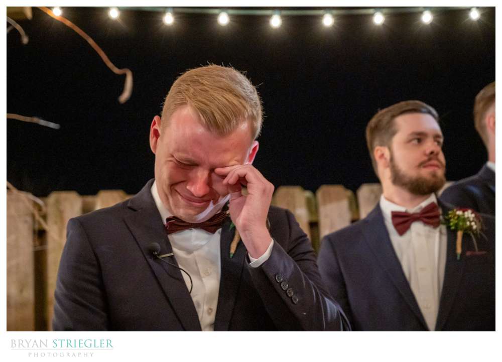 Groom seeing bride walking down the aisle