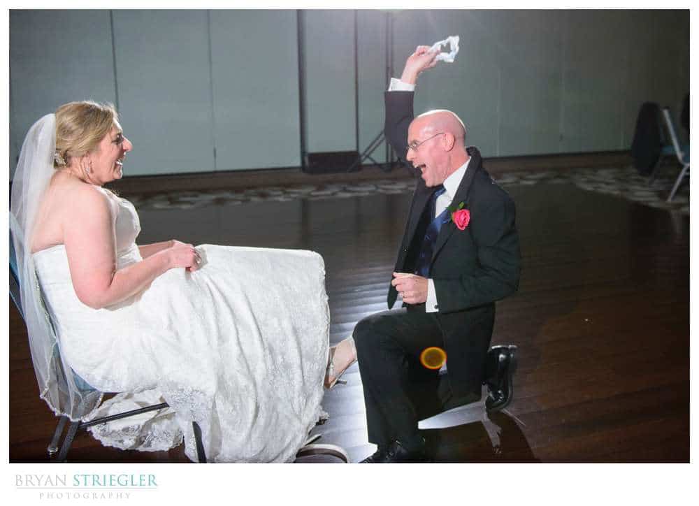 excited groom pulling off garter