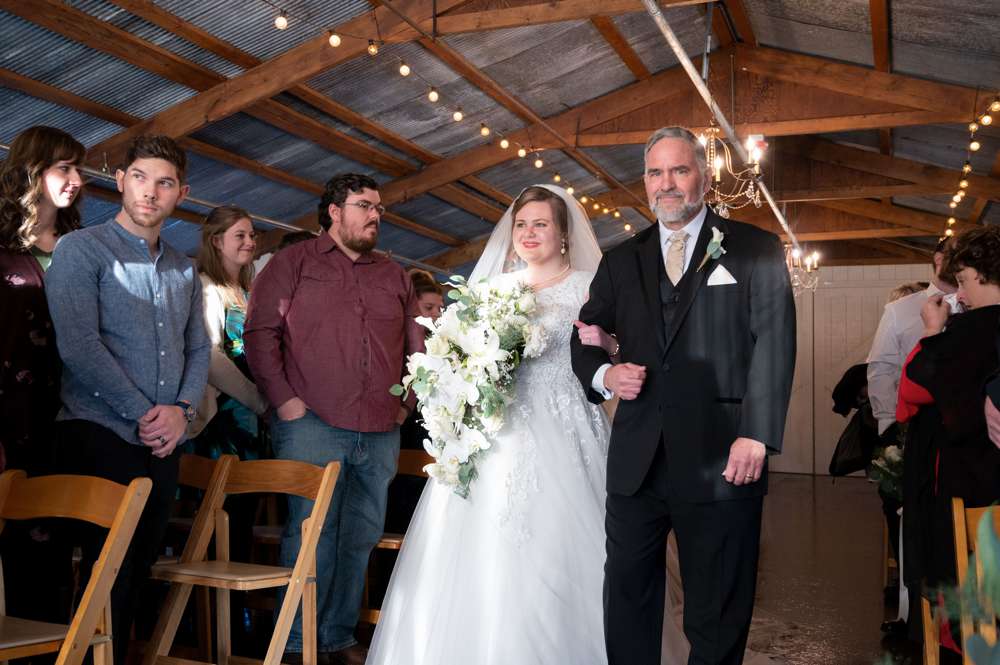bride walking down aisle at Barn at the Springs