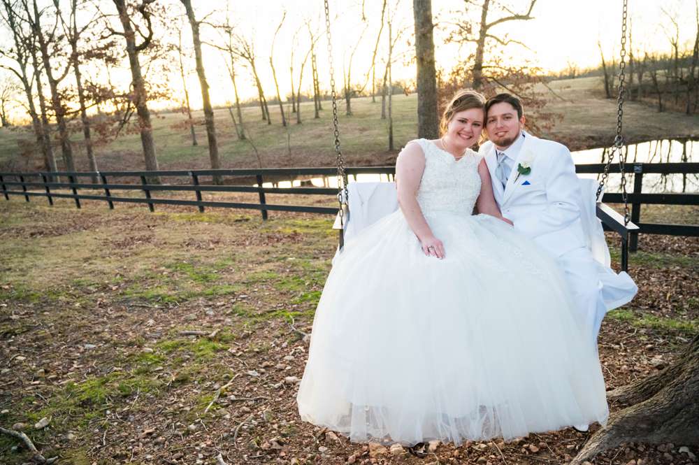 wedding couple on swing at Barn at the Springs